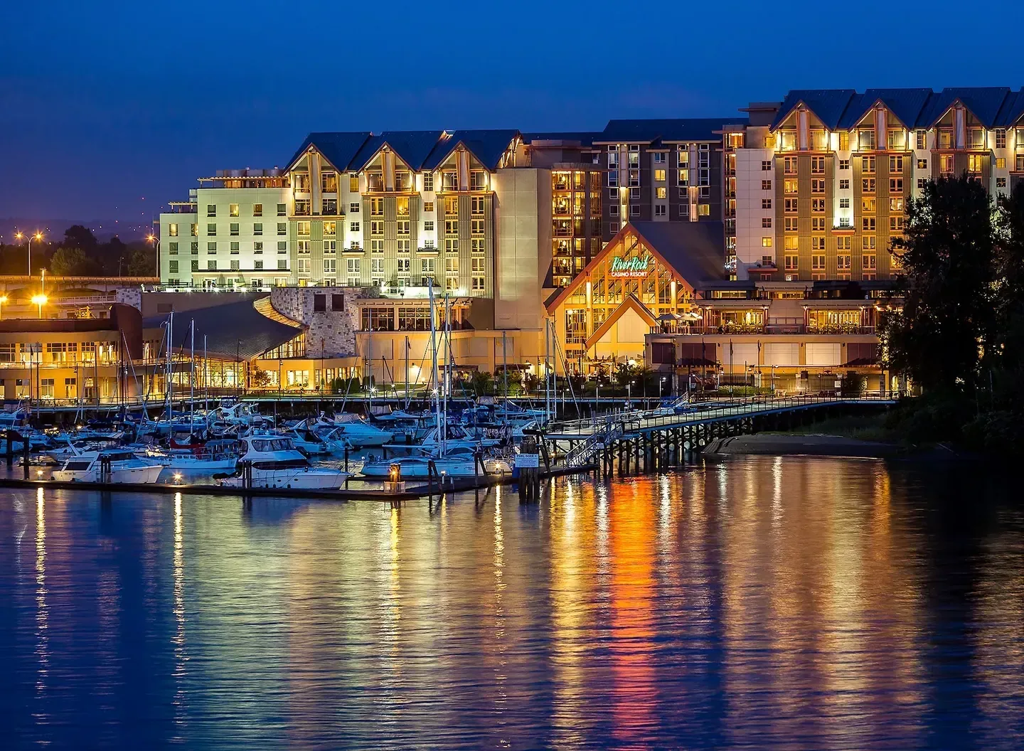 Resort exterior beside open water at dusk